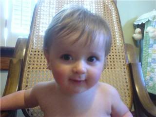 Kyan smiles in the rocking chair